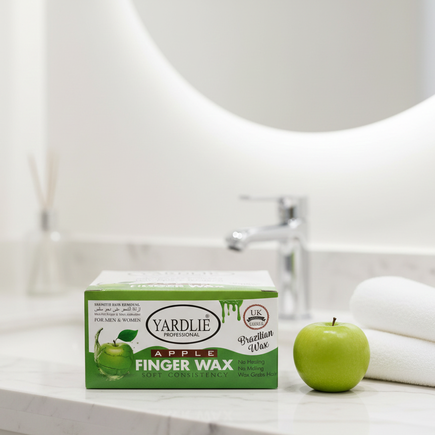 Box of Yardlie Apple Finger Wax on a bathroom counter with a green apple and towels in the background.