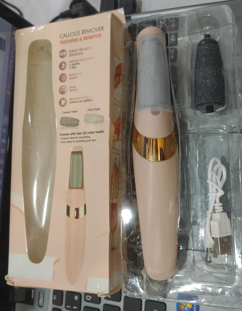 Callus remover with packaging on a laptop keyboard