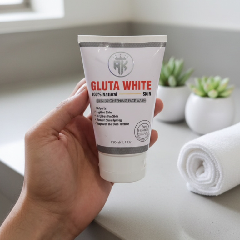Hand holding a tube of Gluta White skin care product on a bathroom counter with plants in the background.